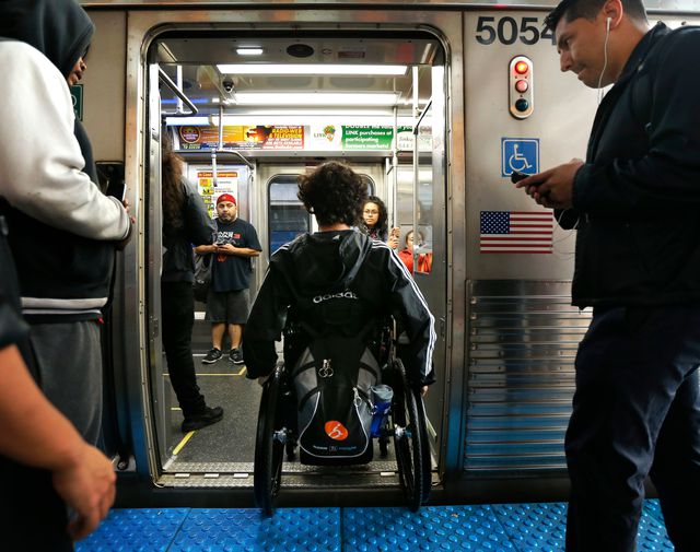Jonathan Annicks maneuvers his wheelchair onto the Chicago Transit Authority's Pink train line in 2016. He was paralyzed by a gunshot wound earlier that year.